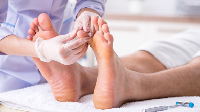 podiatrist checking clients toenails