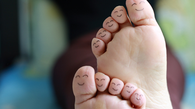 toes with smiley faces drawn on the bottom of them